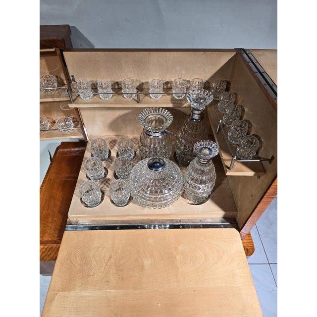 Add a touch of timeless elegance to your home with this stylish Art Deco bar cabinet from the 1920s. Crafted from exotic...