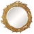 The St Michelle is a sunburst of hand-carved leaves radiating around a round central mirror, finished in a softly aged...