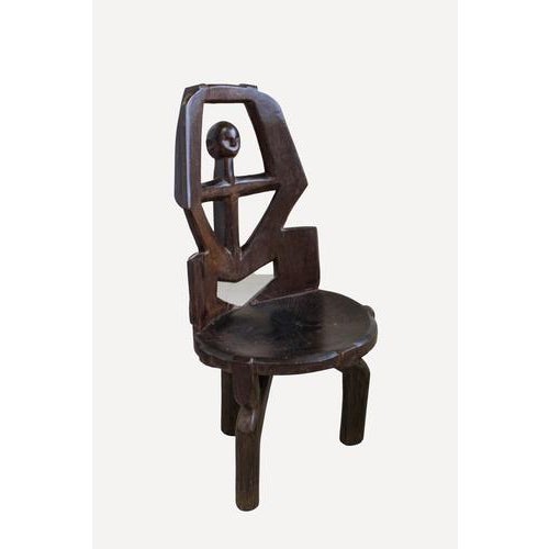 Hand carved wooden chair. The Makonde are an ethnic group in southeast Tanzania and northern Mozambique. Across Tanzania...
