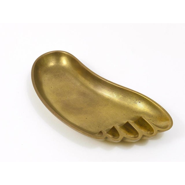 A charming and humorous Austrian brass bowl or tray in the shape of a foot, designed and executed by Werkstatte Hagenauer...