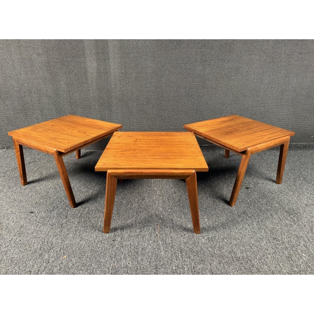 Set of (3) MCM end tables in teak. Featuring all wood construction and sculpted legs. Perfect addition to any area in need...