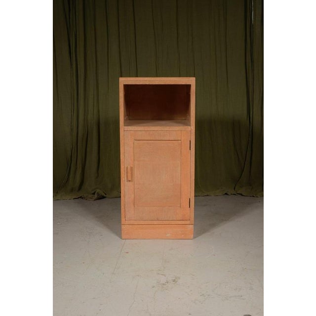 A stylish quarter sawn pale oak bedside cupboard, of panelled construction with a single door and a pigeon hole top, made...