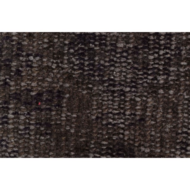 This is a vintage Turkish Oushak rug from the Mid 20th Century. The piece was hand-knotted.