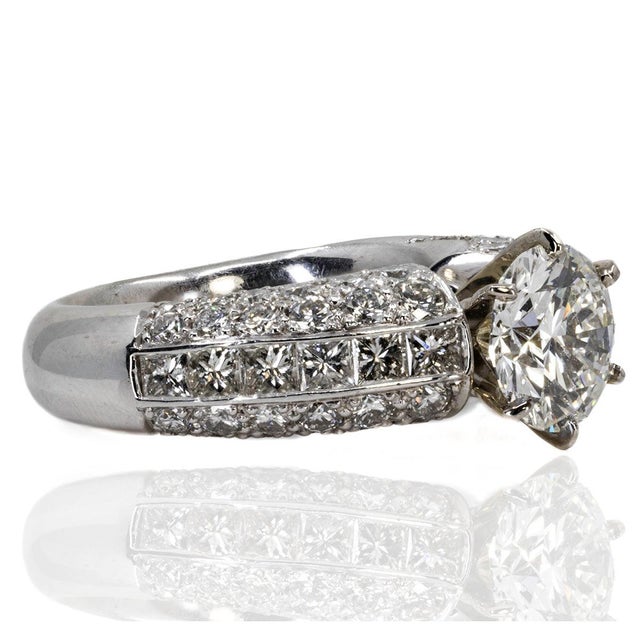 Platinum Ring with one GIA certified ( #6183951846) 2.02 carat G color SI1 clarity round brilliant and 12 Princess cut and...
