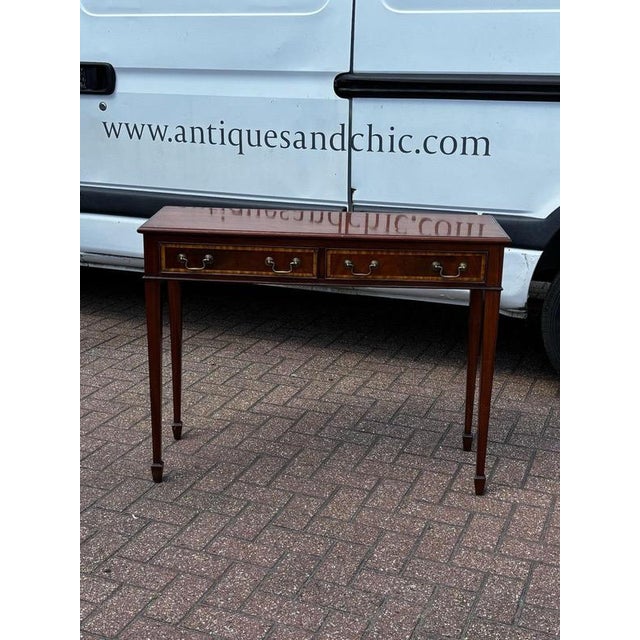 Console Table, Inlaid Mahogany with 2 Drawers. Sizes :- 102 cms wide, 36 cms depth, 79 cms high. This is an old piece and...