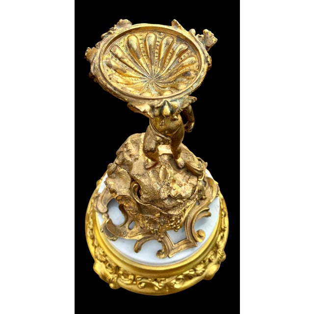 The piece is early 20th c., French, designed in the flamboyant Rococo Revival (Louis XV) style. The piece features a...