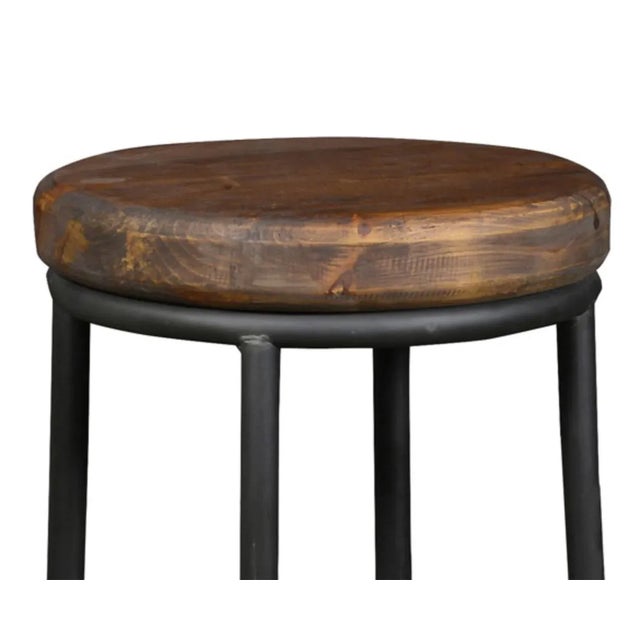 Modern rustic counter stool with salvaged walnut stain finish pine wood seat and blackened iron base. Functional space-...