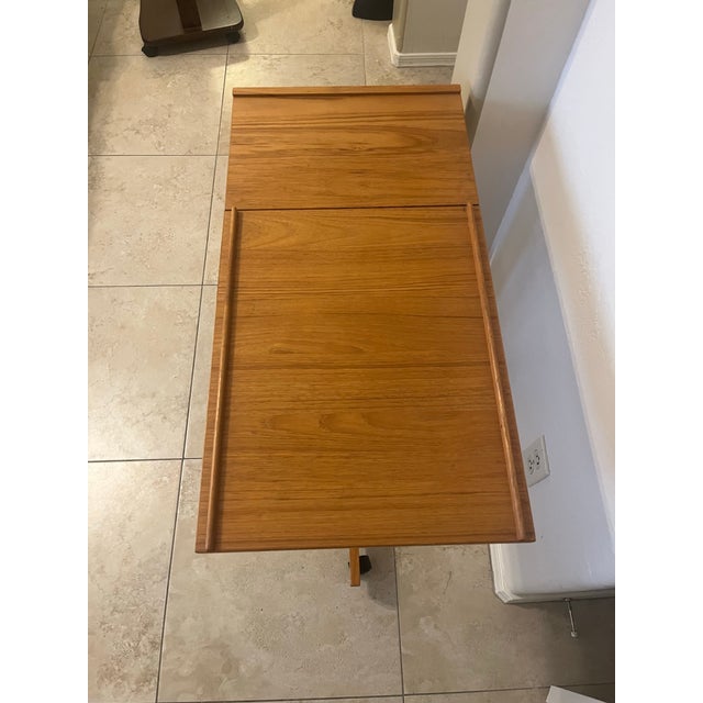 This is a Furbo Spottrup Style Mid-Century Danish teak rolling adjustable tray table. Adjusts up to 38” high. The table...