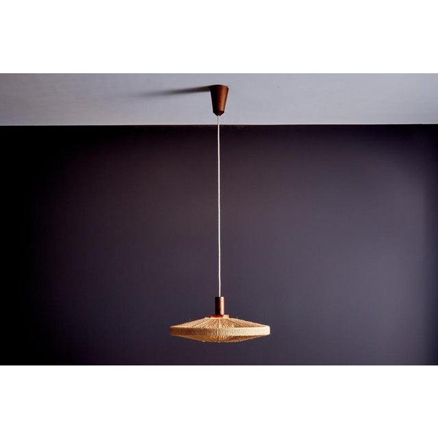 Pendant lamp by Temde Leuchten, commonly referred to as the “UFO” model. The flat, disc-shaped form features a central...