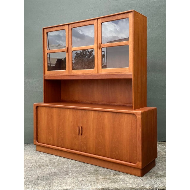 Exemplifying the pinnacle of Danish Modern design, this monumental teak sideboard and hutch by the renowned maker Dyrlund...