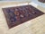 This vintage wool area rug is hand-knotted in the Baluch tribal design tradition. Measuring 6'8" x 10'4" (202 x 316 cm),...
