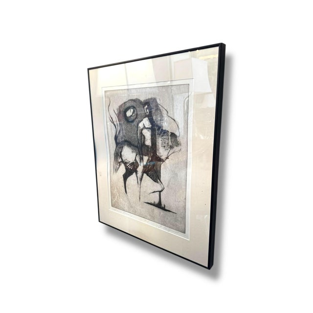 Expressive and atmospheric, “Extonis Dream” by G. deGroat is a striking framed artwork featuring gestural linework and...