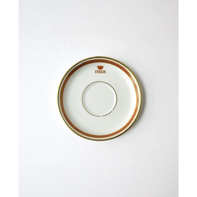 An Italian porcelain saucer dish by designer Richard Ginori, circa mid-20th century, Italy. Saucer/dish has a red and gold...