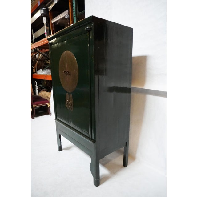 Imported Large Gem-Tone Green Lacquer Wedding Cabinet Designed in the Ming style, its beauty lies in details such as the...
