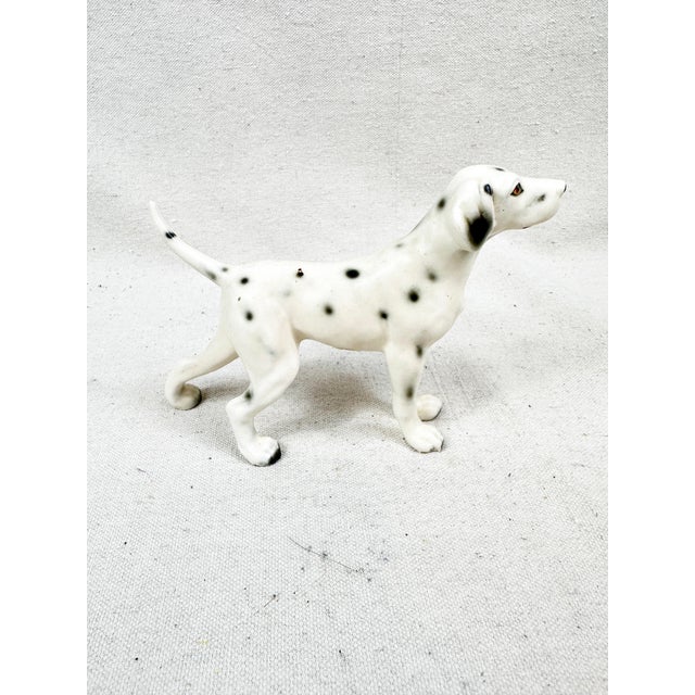 Add a touch of mid-century charm to your shelves with this vintage ceramic Dalmatian figurine. This collectible piece...