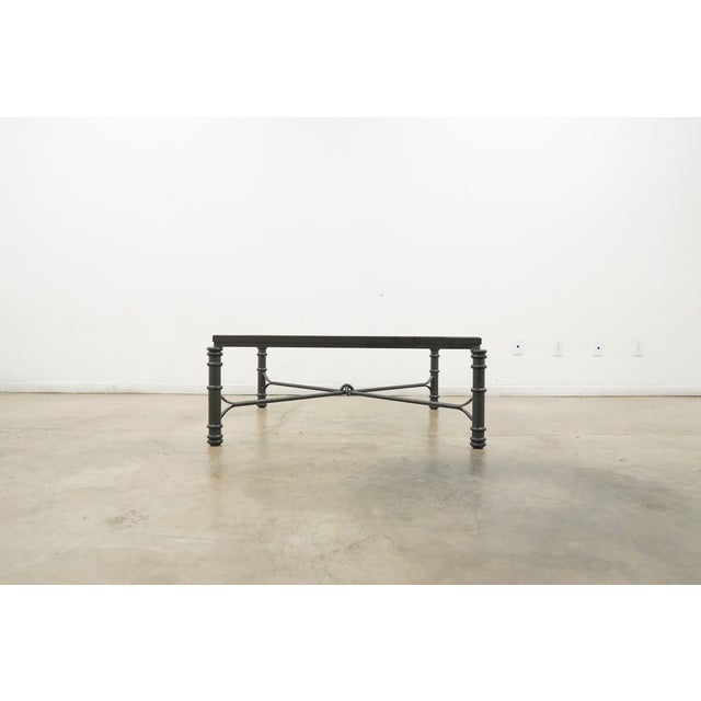 Dating to circa 1980, this vintage Giacometti-style coffee table features a distinctive Etruscan-inspired design with a...