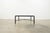 Dating to circa 1980, this vintage Giacometti-style coffee table features a distinctive Etruscan-inspired design with a...
