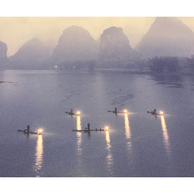 This signed photograph by Keith (Guo Ji) Liang, titled “Fishing at Night,” captures a serene nocturnal scene of fishermen...