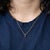A 0.61-carat red rhodolite garnet round set in solid 14K yellow gold as a classic solitaire pendant. Rhodolite is garnet...