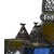 A vintage Moroccan chandelier of pierced metalwork inset with jewel-toned glass — cobalt, emerald, amber, and ruby panels...