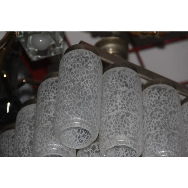 This Pop Art influenced Murano glass waterfall chandelier dates from the 1970s. Up to 250V (Europe/UK Standard).The wiring...