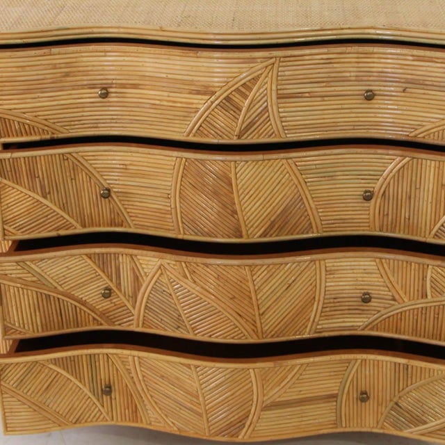 Incredible curved rattan chest of drawers with four drawers featuring a foliage motif. The foliage adorning the front and...