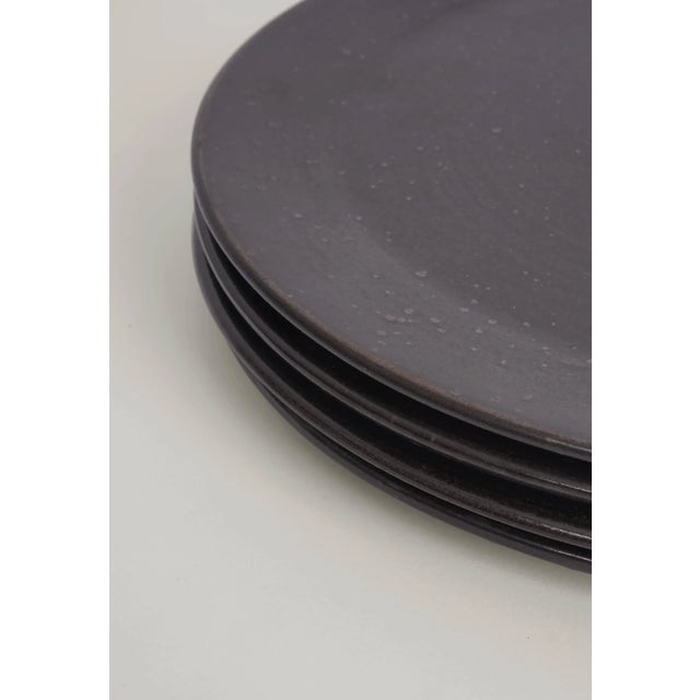The four matte black glazed stoneware plates are designed by the Designer Eliza Helmerich for REH (Germany). Each plate is...