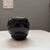 The vase or jar is a hand-coiled, stone-polished, and traditionally fired piece featuring his signature deeply carved...