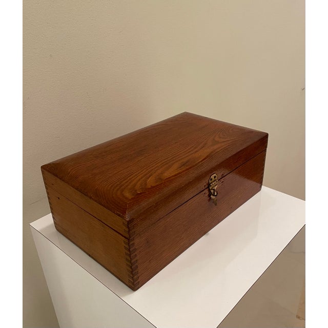 A beautifully crafted vintage solid wood storage box with a quiet, classic presence reminiscent of an English gentleman’s...