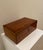 A beautifully crafted vintage solid wood storage box with a quiet, classic presence reminiscent of an English gentleman’s...