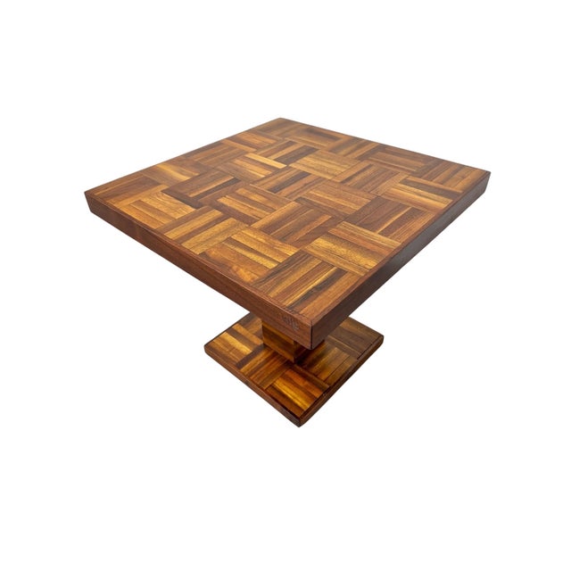 A distinctive Mid-Century Modern side table featuring a beautifully crafted butcher-block parquet walnut surface arranged...