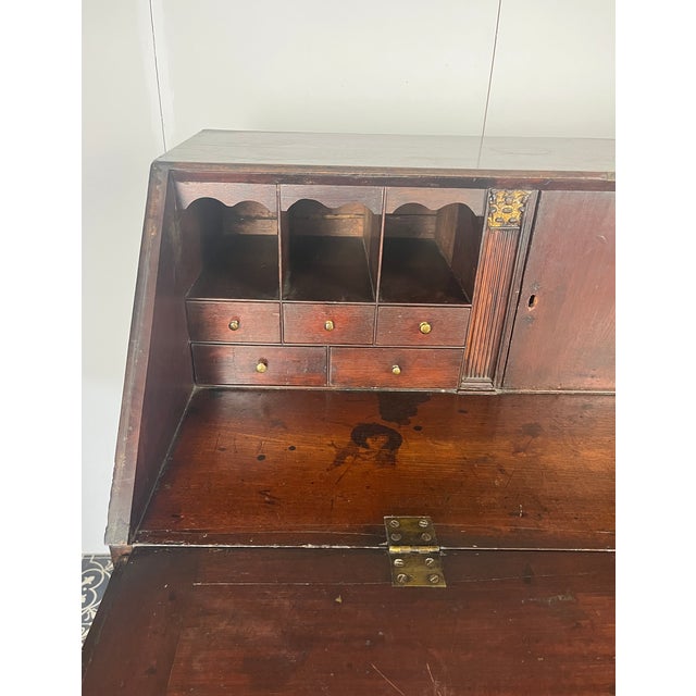 A beautiful Georgian mid-18th-century antique mahogany bureau. The antique mahogany bureau has a fall front that opens to...