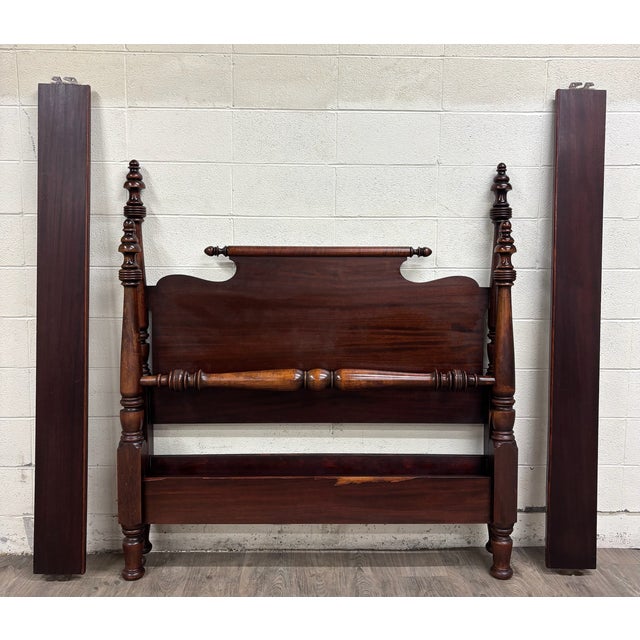 This is an impressive antique American Empire mahogany full sized four-poster bed featuring exceptionally tall turned...