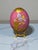 The Franklin Mint House of Faberge Imperial Porcelain Pink Floral Gilded Jeweled Egg is a stunning decorative collectible...
