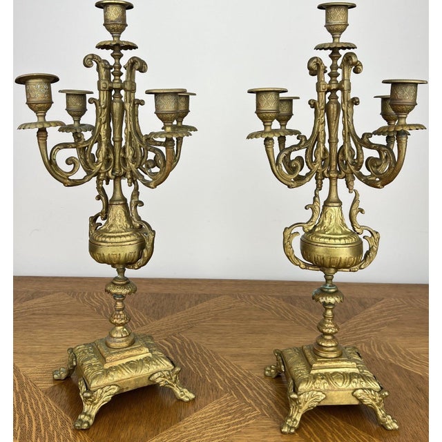 A stunning pair of Vintage French candelabras featuring elegant five arm candle holders and beautifully ornate decorative...