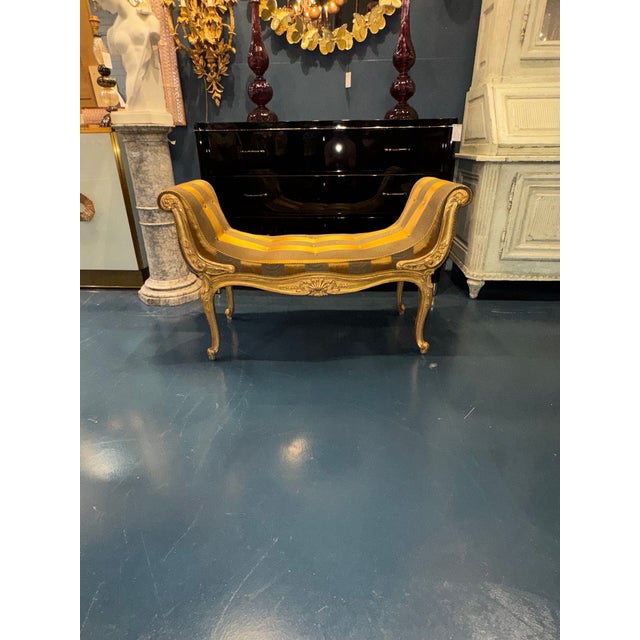 This 19th century French Louis XV giltwood bench is a stunning piece of antique furniture. The intricate giltwood...
