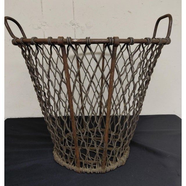 Antique Industrial Wire basket. Heavy weight basket with 2 handles. It is 19" wide x 16" high, it is 11" wide at the...