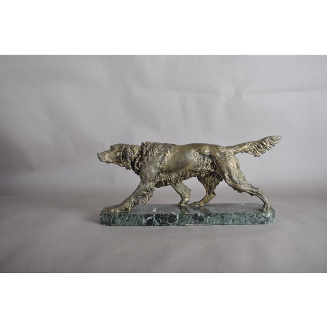 English Setter sculpture dating to the 1930s, in the animalier tradition. The dog is modelled in an alert sporting pose,...