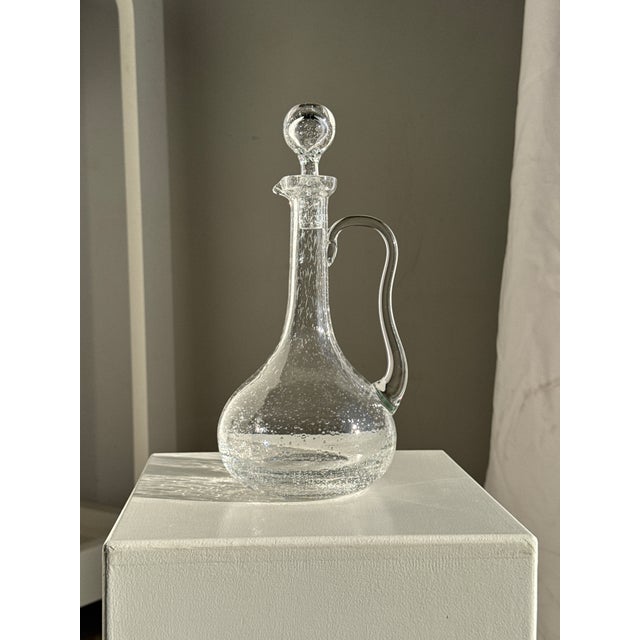 Large clear glass carafe with Biot stopper. Height: 32cm; Diameter: 14.5cm; Weight: 1.36kg. Founded in 1956 in Provence,...