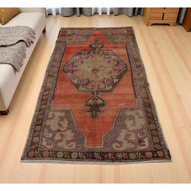 This 1960s hand-knotted Oushak rug brings the warm, time-softened character of Central Anatolian weaving into a versatile...