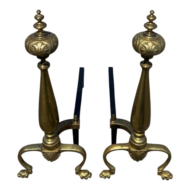 Beautiful pair of antique 1920s brass fireplace andirons, professionally refurbished with polished brass and black iron...