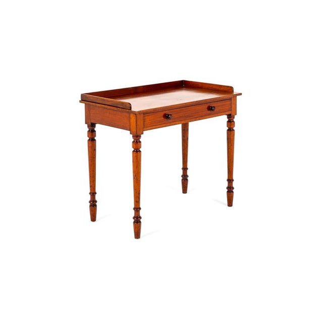 A simple victorian mahogany hall table with a three quarter gallery back. The table is completed by a single smooth...
