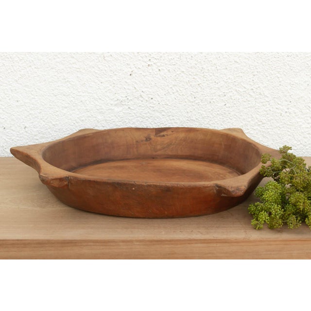 The sculptural form of this vintage bowl takes center stage. Carved from a single piece of solid hardwood, it features a...