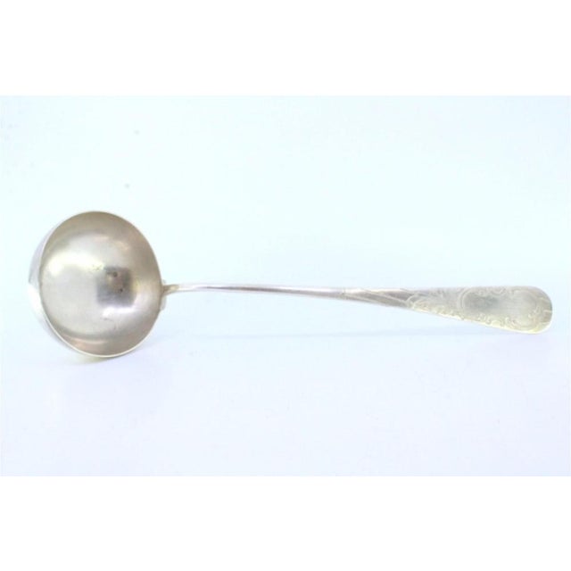 Shell-Shaped Silver Soup Ladle with Engraving and Monogram Card, in Very Good conditions. Designed 1890 to 1919 This piece...