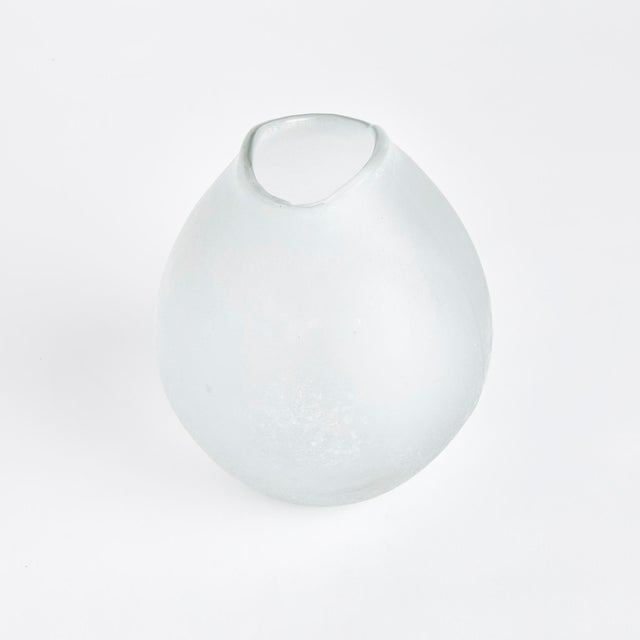 Natureinspired, this hand blown glass vase has a bulbous shape and melted edge rim detail. The frosted glass only adds to...