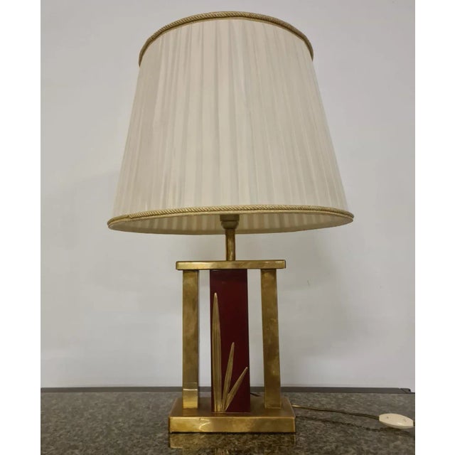 Hollywood Regency style table lamp. Red and brass lacquered lampshade with fauna decorations. The lamp is Hollywood...