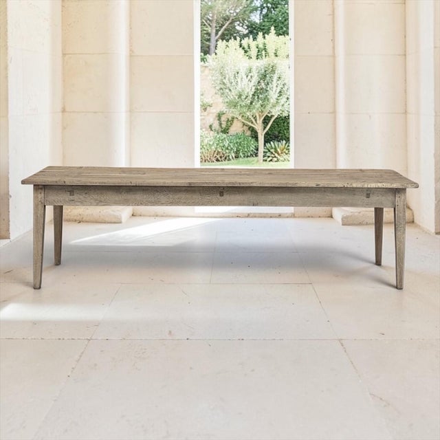 An 18th century Grand Rustic Country French farm table from Normandy, its long, clean silhouette carrying the quiet grace...