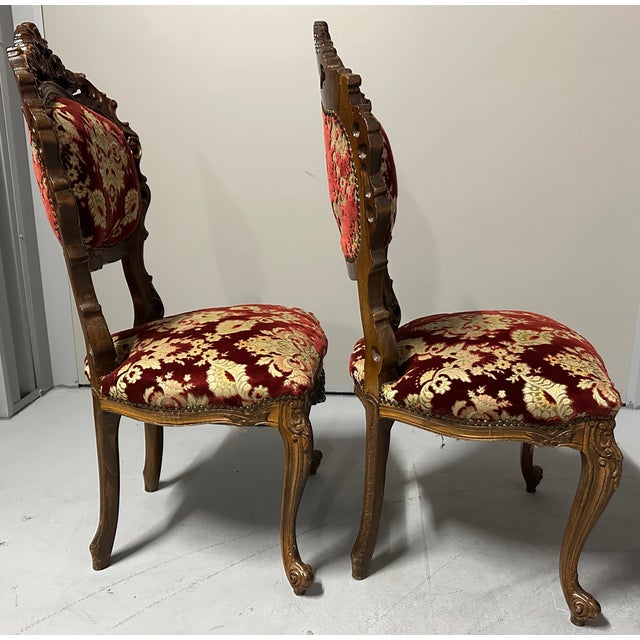This pair of ornate, antique Italian Venetian-style side chairs (#1 of 3 available) feature extensive hand-carved details...