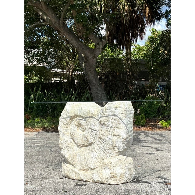 Make a stunning statement with this captivating vintage console table, featuring a dramatic sculptural nautilus shell...