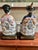 An exceptional, highly detailed pair of mid-20th-century Japanese export hand-painted porcelain statues depicting a seated...